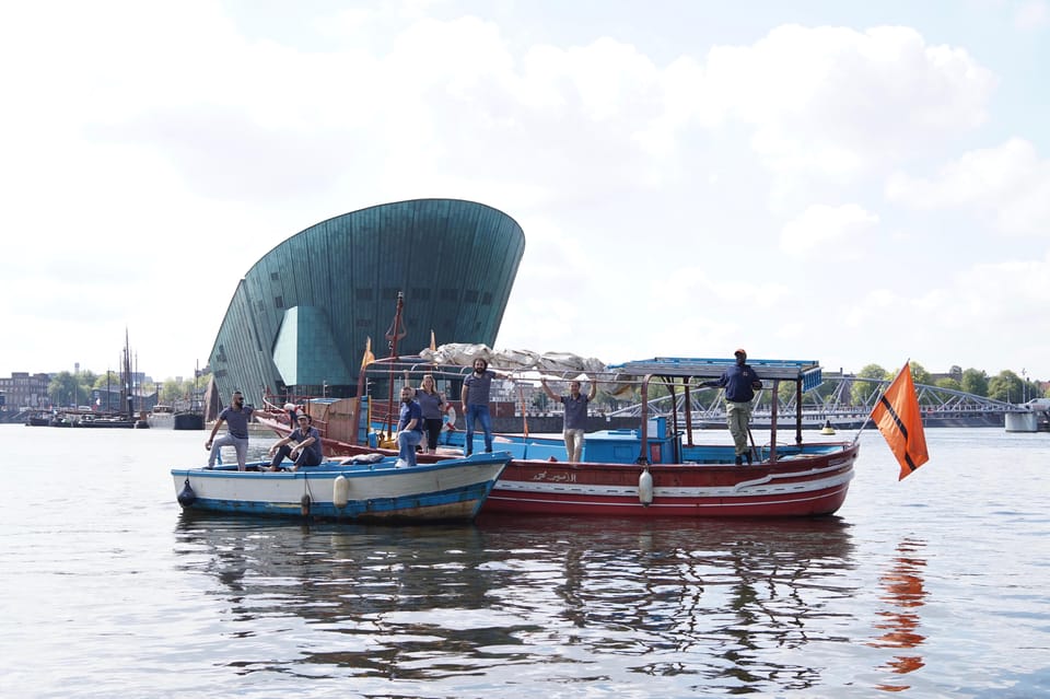 Amsterdam: Canal Cruise on a Wooden Refugee Boat - Weather Reality: Open Boats, Rain or Shine, and What to Bring