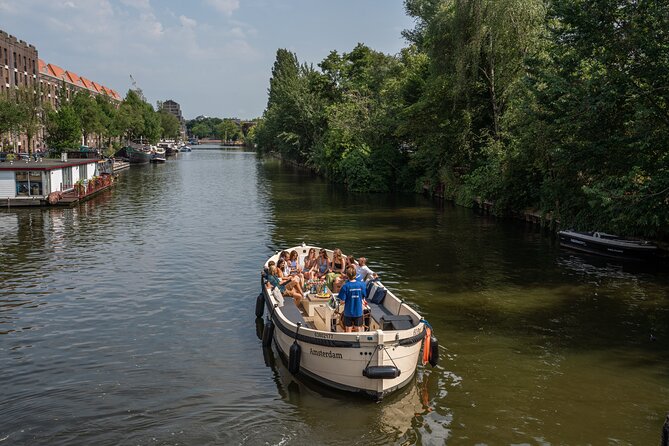 Amsterdam: Evening Candle Light Cruise With Wine & Cheese - Onboard experience: guides, boat setup, and the drink/cheese reality check