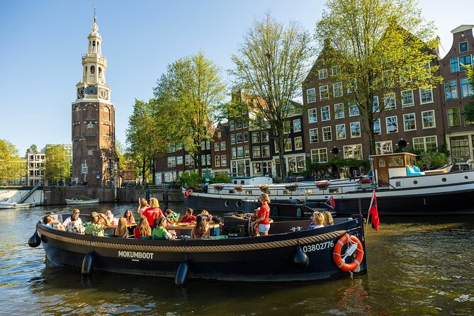 Amsterdam: Guided Open Boat Canal Cruise Unlimited Drinks Option - What you get on board: live guide, comfort gear, and drinks
