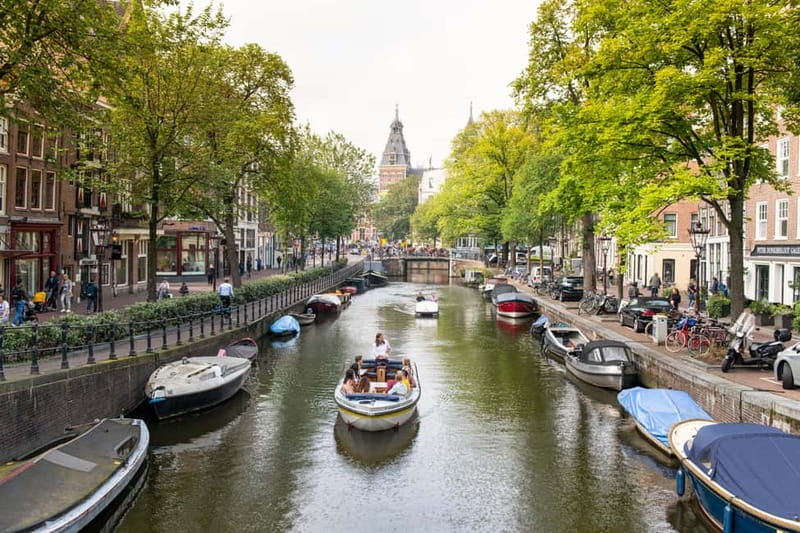 Amsterdam: Open Boat Tour of Canals with Expert Local Guide - From Amsterdam Centraal Station to the canal front you actually want to see