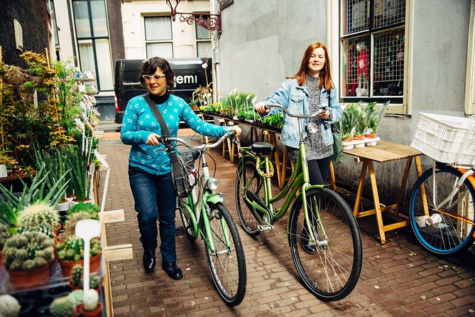 Amsterdam PRIVATE Bike Tour With Locals: Bike & Local Snack Included - Jordaan and canal-side neighborhoods: where the local feel shows up