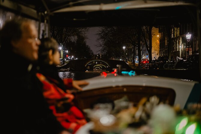 Amsterdam: Private Romantic Evening Canal Cruise + Bubbles/Snacks - Skinny Bridge lights and love stories tied to landmarks