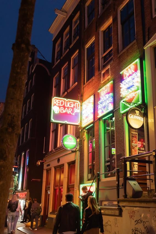 Amsterdam: Red Light Tour Exclusive + Peep Show - Meeting at Dam Square: how the tour sets expectations fast