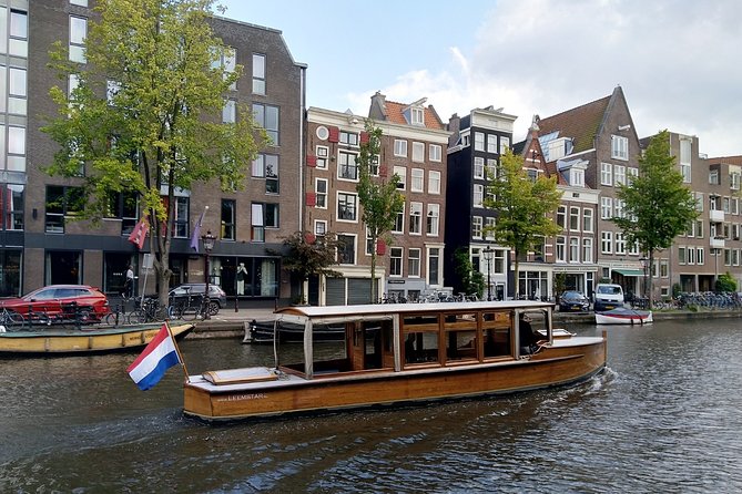 Amsterdam small-group canal cruise in 1920s saloon boat - Comfort check: heater, blankets, covered seating, and onboard drinks