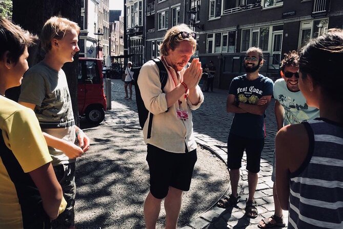 Amsterdam Walking Tour with a local comedian as guide - Stop 4: Grimburgwal canals and the happy birthday message lesson