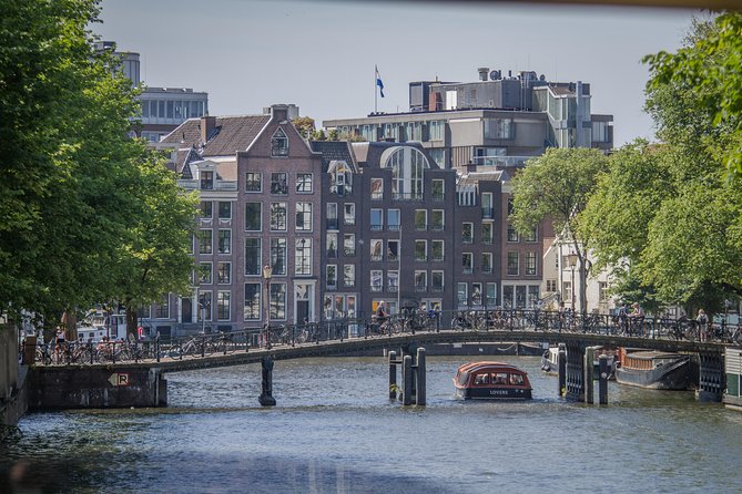 Anne Frank Private Bike Tour in Amsterdam - Passing the Dutch National Opera & Ballet and the Magere Brug