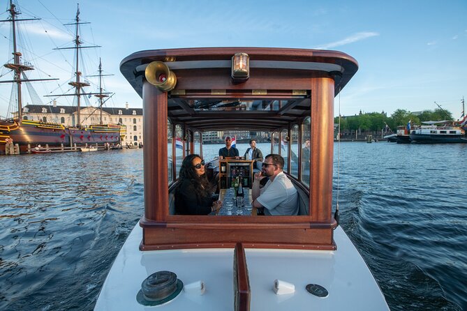 Private Boat Tour Amsterdam - 90 Min incl. welcome drink on historic saloon boat - 90 Minutes of Canal Passing: How the Guide Keeps It Interesting