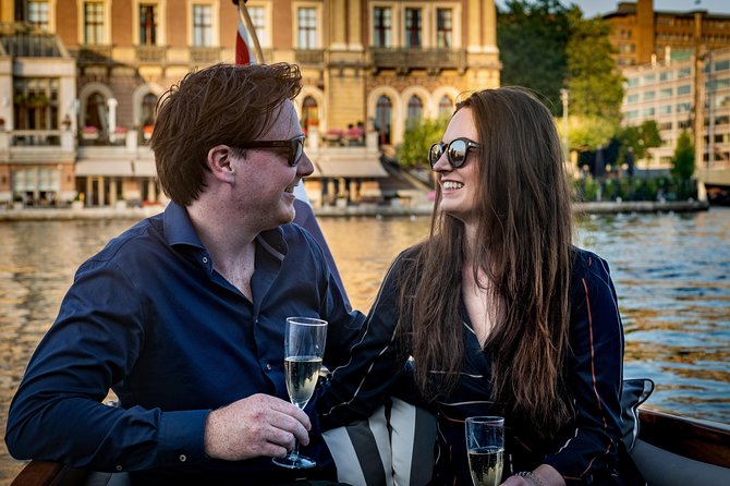 Private Boat Tour Amsterdam - 90 Min incl. welcome drink on historic saloon boat - Welcome Drink, Bottled Water, and Coffee or Tea: The Included Comforts
